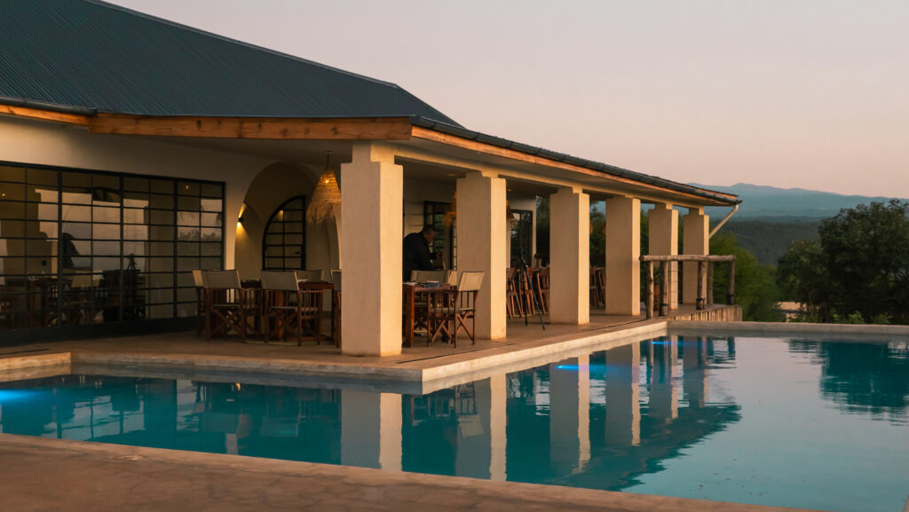 Manyara bet view lodge swimming pool with a terrace and pillars