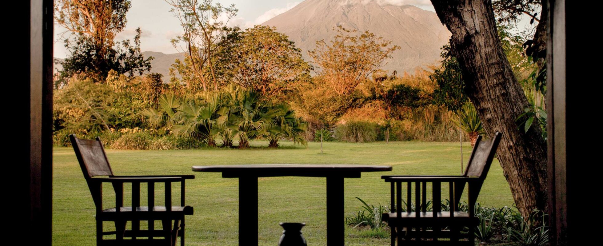 Veranda of Legendary Lodge with two chairs and a table with a mountain in the background