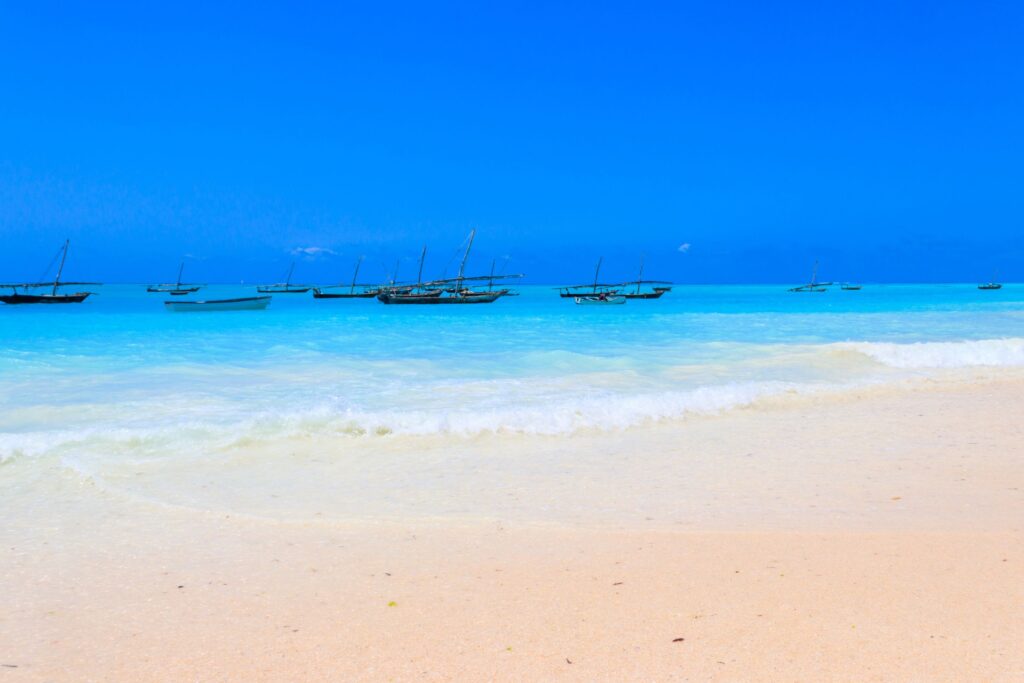 Nungwi Beach with turquoise see and wooden dhow boats