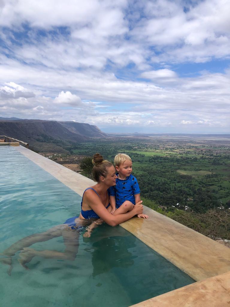 Mom and son sitting at the pool in Tanzania